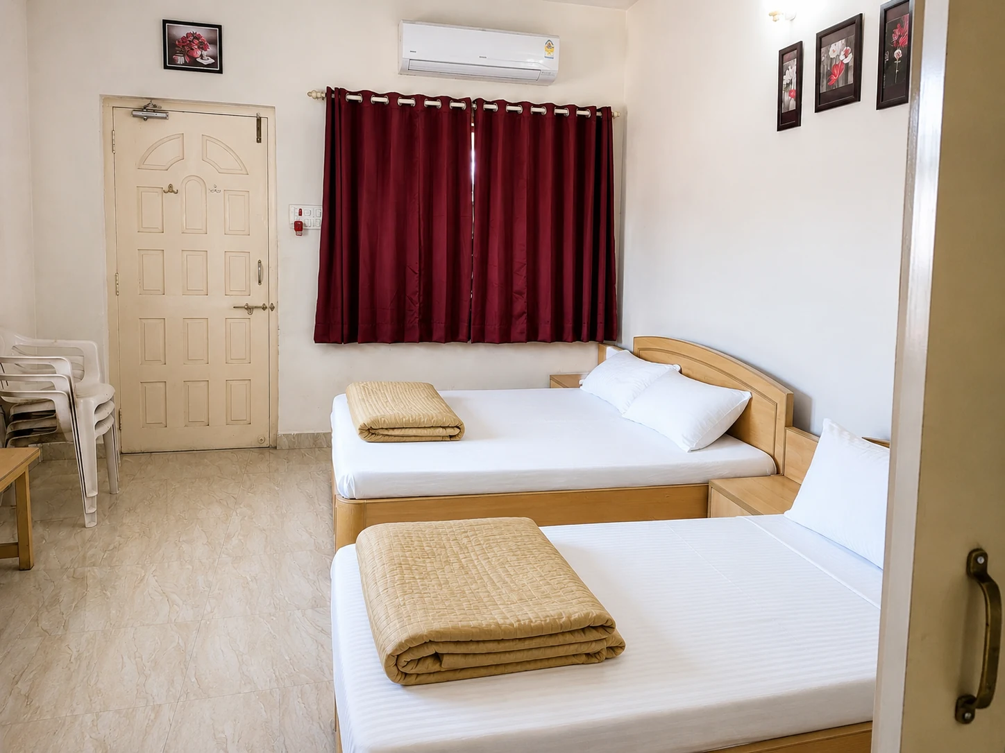 Classic twin room with two single beds, burgundy curtains, and air conditioning.