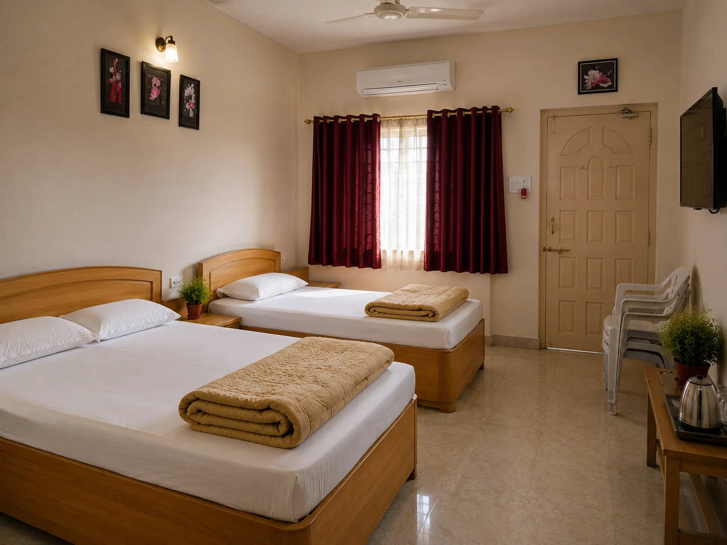 Comfort room with twin beds, framed artwork, and a bright curtained window.